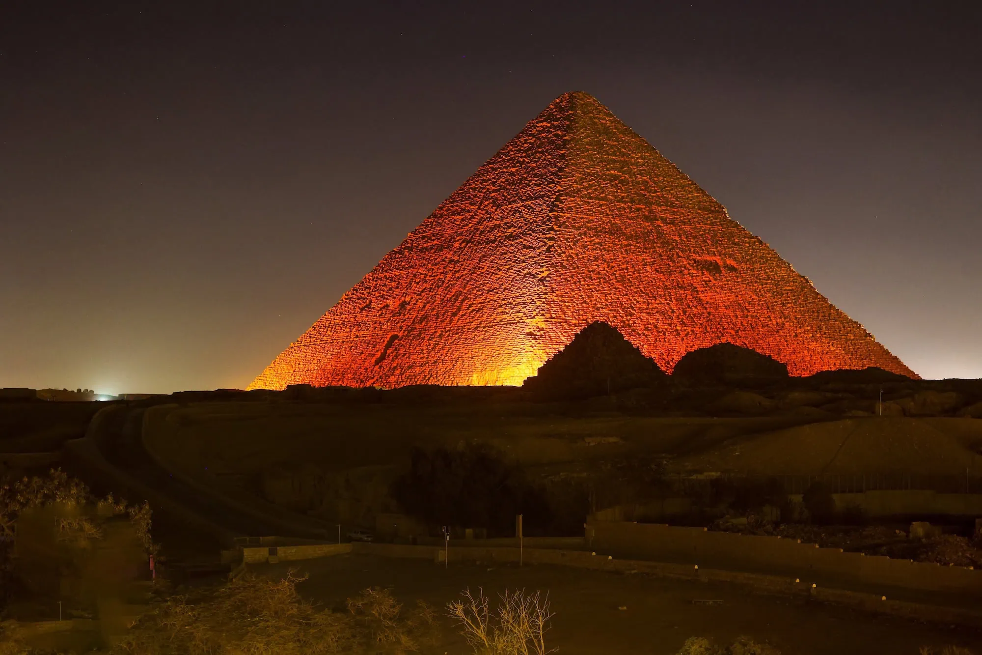 Great Pyramid of Giza illuminated at night with dramatic lighting