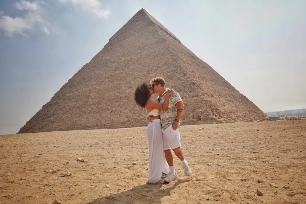 Couple kissing in front of the Great Pyramid of Giza, Cairo