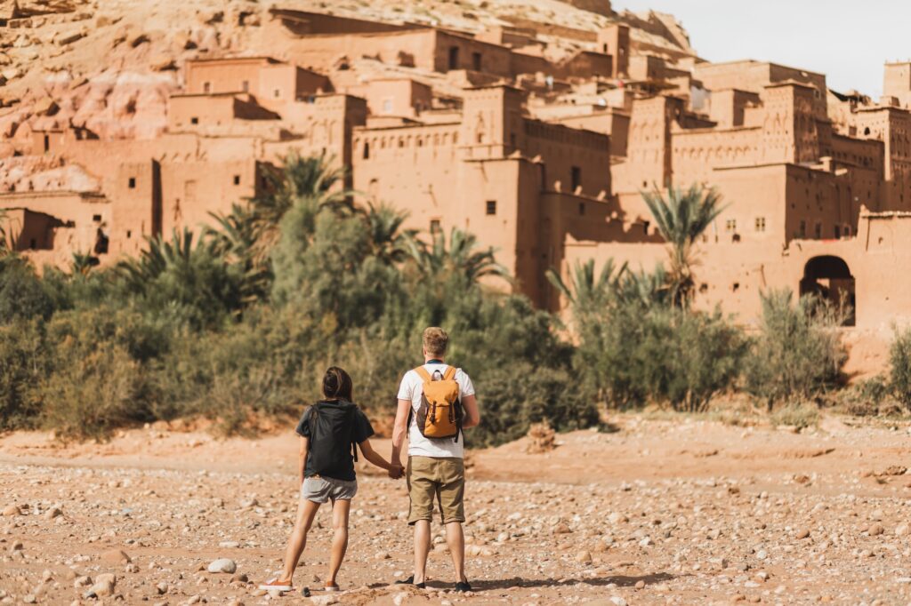 Couple of backpacker travelers on background Ait Ben Haddou ksar in Ouarzazate