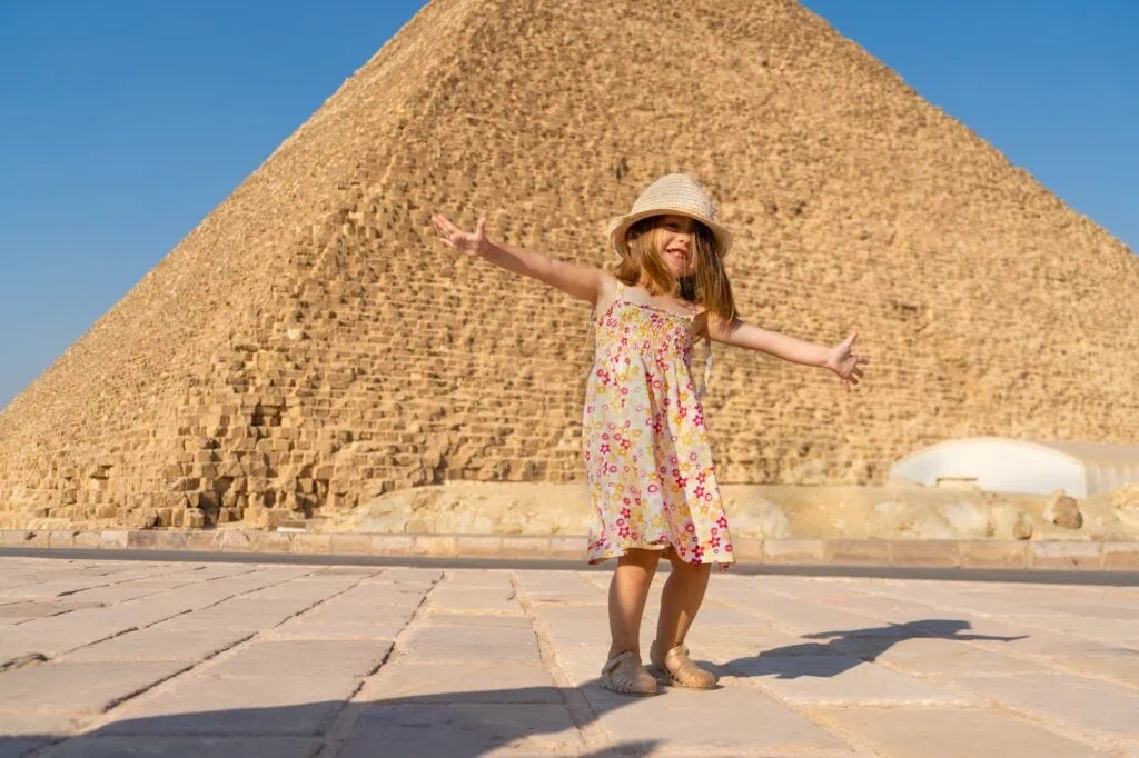 Young girl dancing in front of the Great Pyramid of Cheops on the Giza Plateau, Great Pyramid of Cheops, Giza