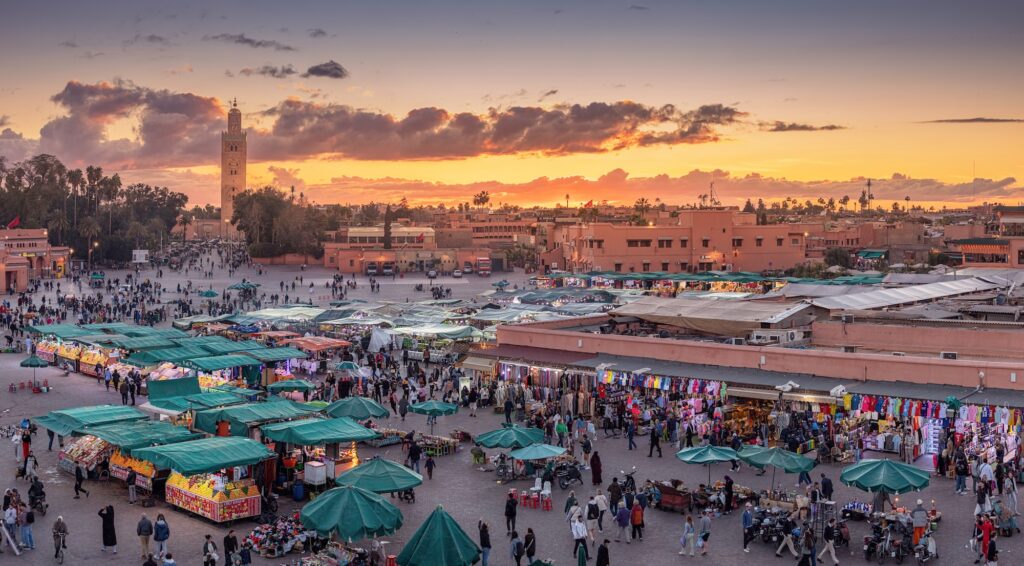 Djemaa el Fna square at sunset with Koutoubia Mosque Minaret in the background