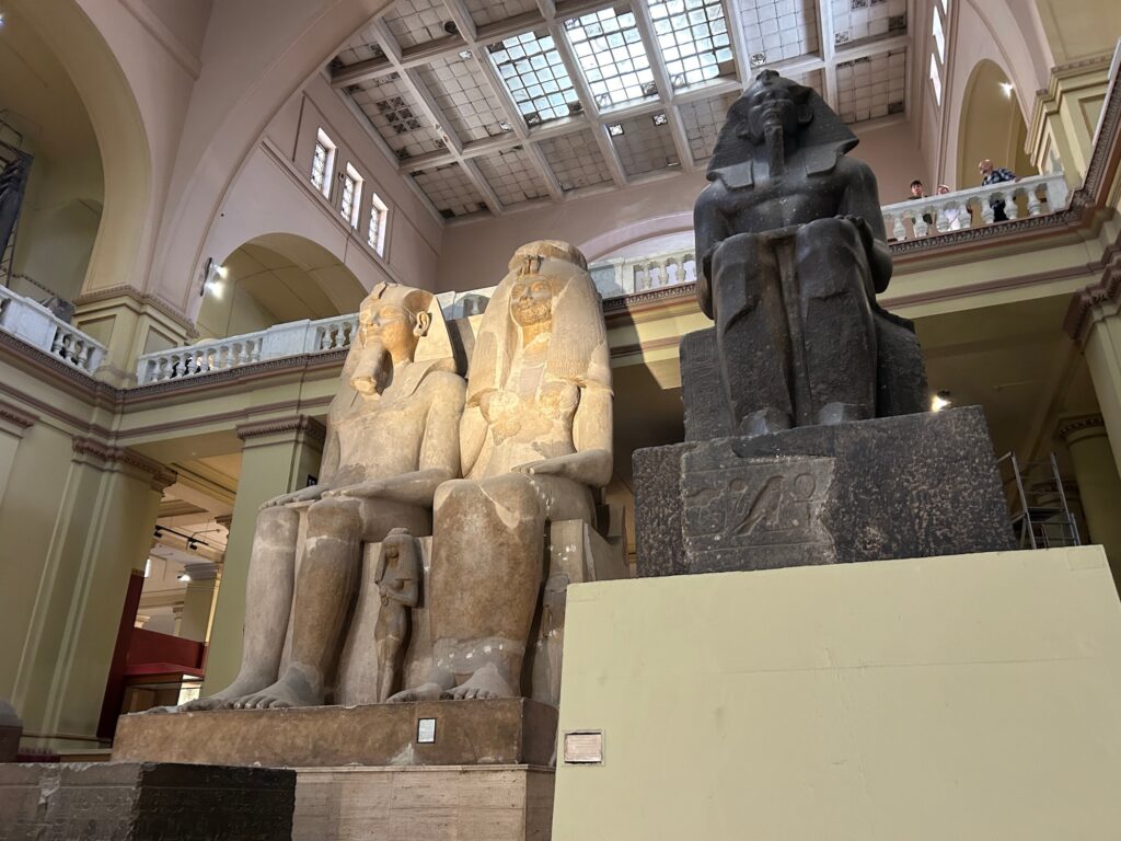 Giant statues in the main atrium of Egyptian museum of King Amenophis III Queen Tyi with three daughters. Cairo