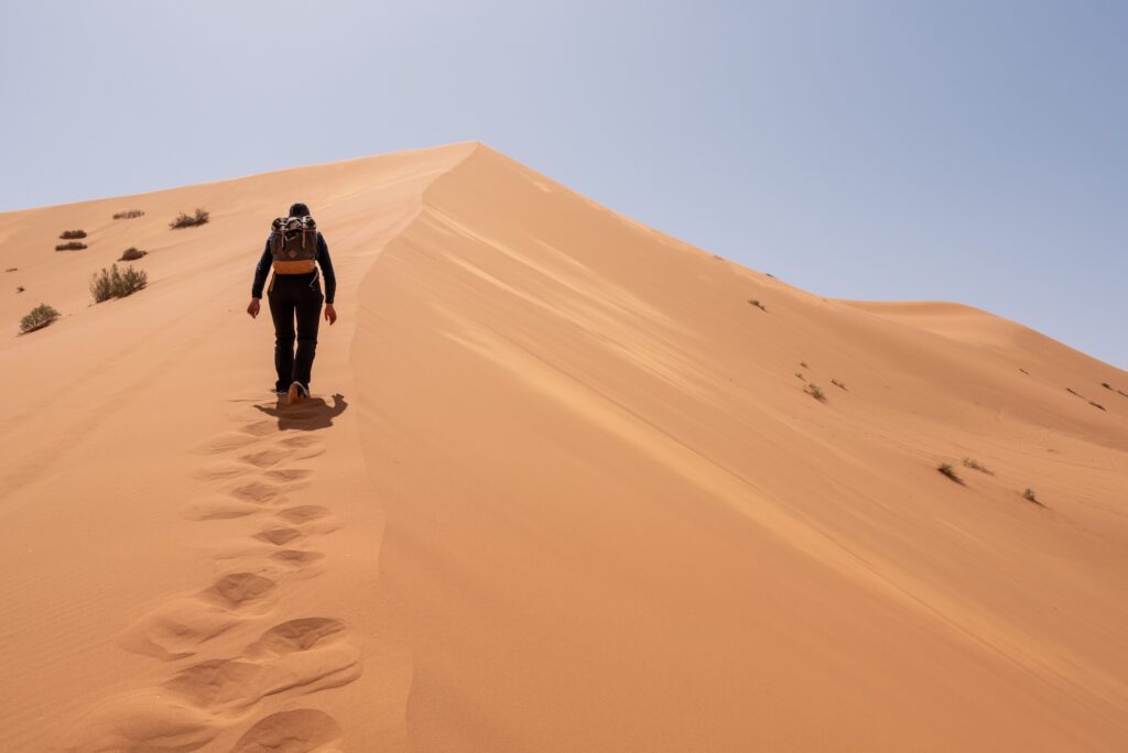 Hiking up the Great Dune of Merzouga in the Erg Chebbi desert
