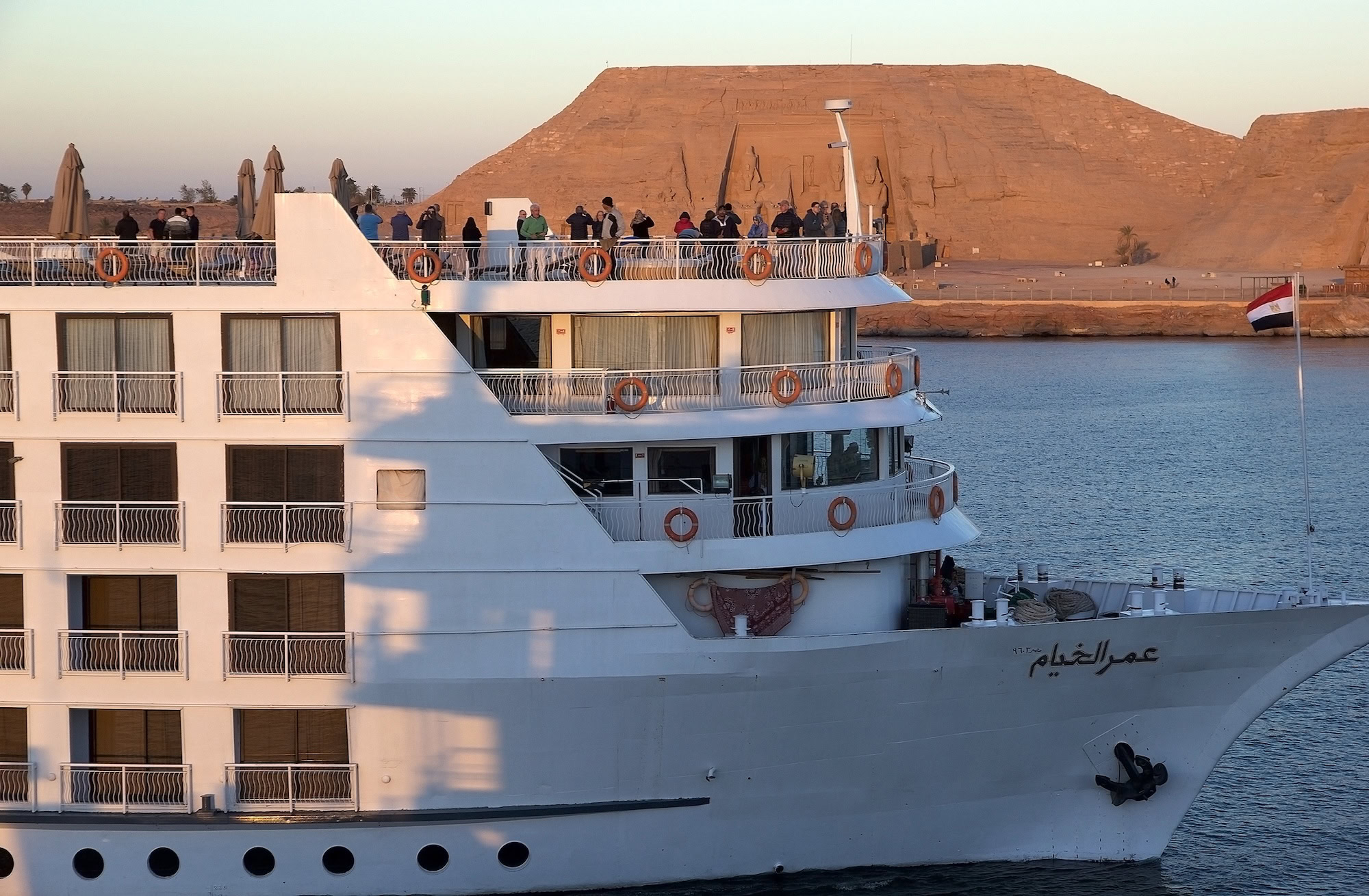 Cruise ship on river with Abu Simbel temples in background