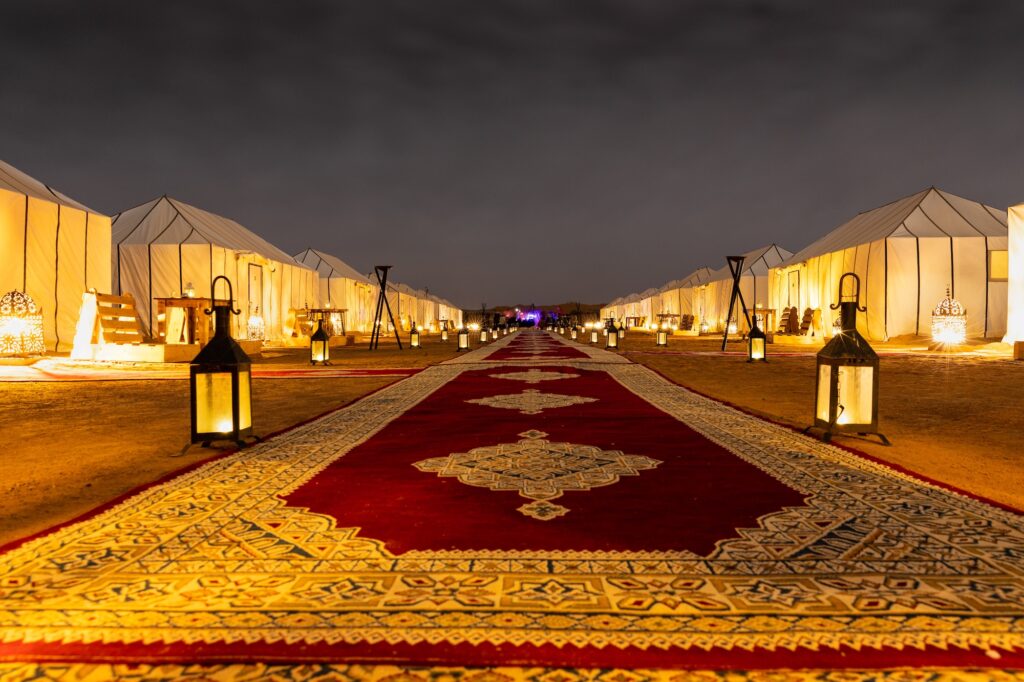 Main path accross the tents and the lanterns of Golden Camp site in Sahara Desert Merzouga Morocco
