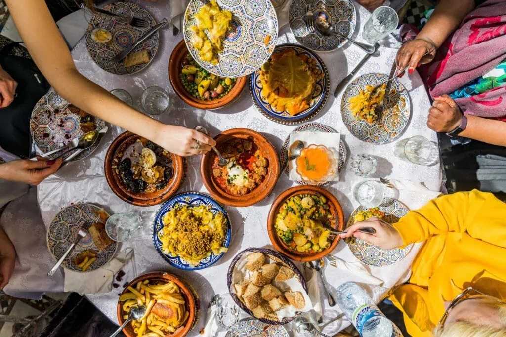 Top view of traditional Moroccan dishes and tagines arranged on a dining table in Marrakech