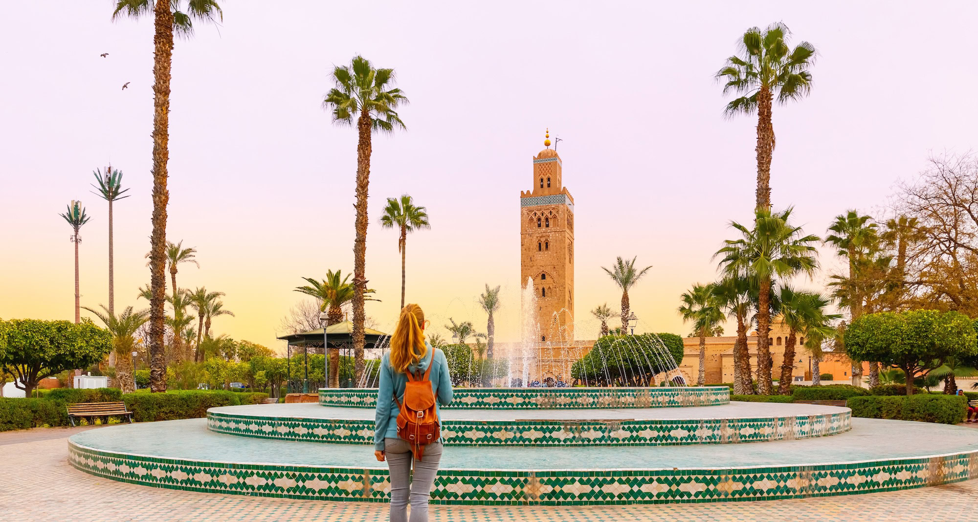 Woman looking at Koutoubia mosque minaret Tourism in Marrakech