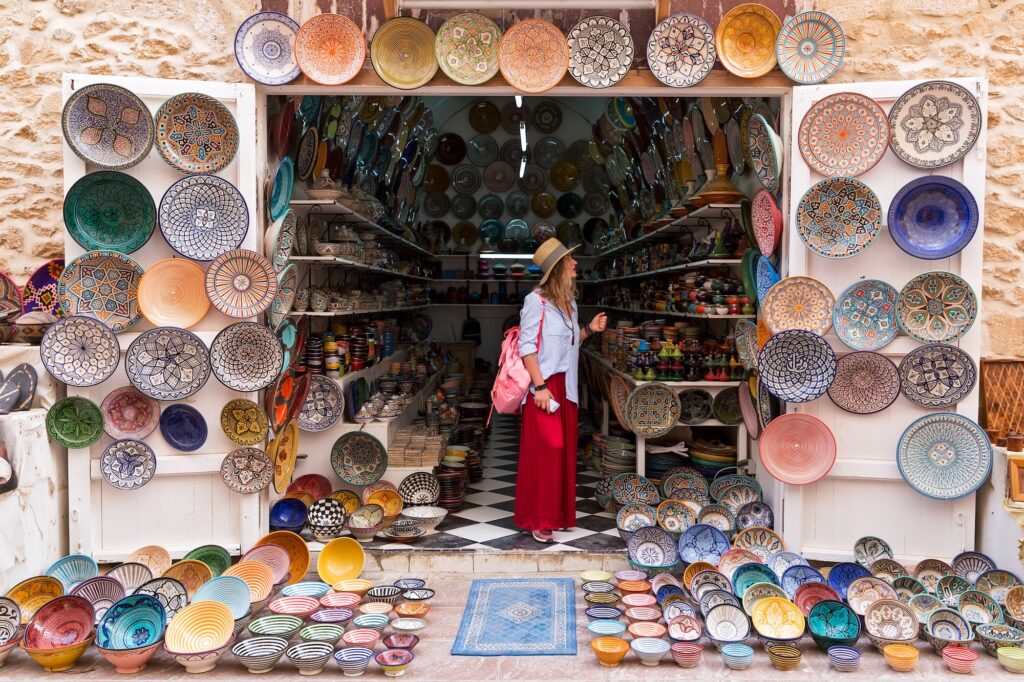 Tourist shopping for Moroccan plates in a local store