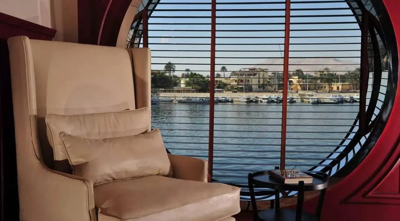 Cozy library on MS Mayfair with books and armchairs