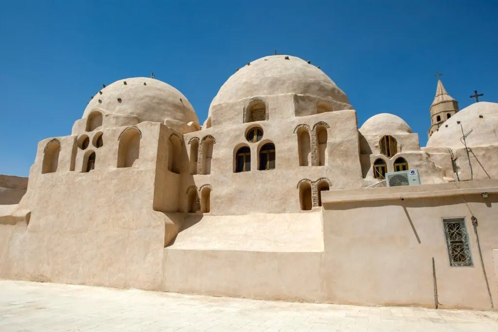 A domed church section with brick and stonework and a Coptic cross, Saint Bishoy Monastery, Wadi El Natrun