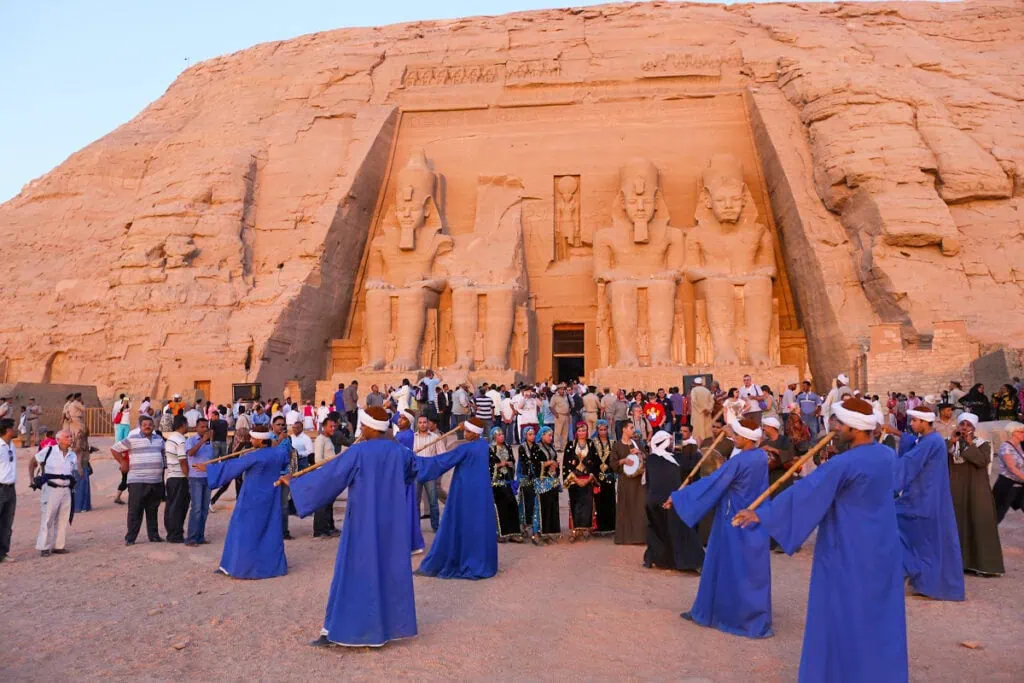 Dancers performing near the rock-cut temple as tourists watch during the sun festival, Abu Simbel Temple