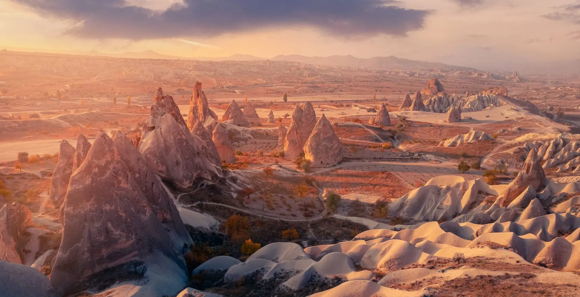 Aerial top view Sunset landscape Cappadocia stone and old cave house in Goreme national park Turkey sunlight 1905x976 crop 52 47