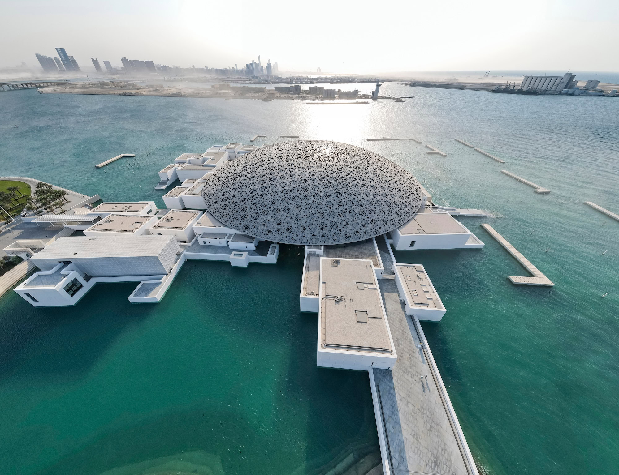 Louvre Abu Dhabi museum with distinctive geometric dome architecture surrounded by water
