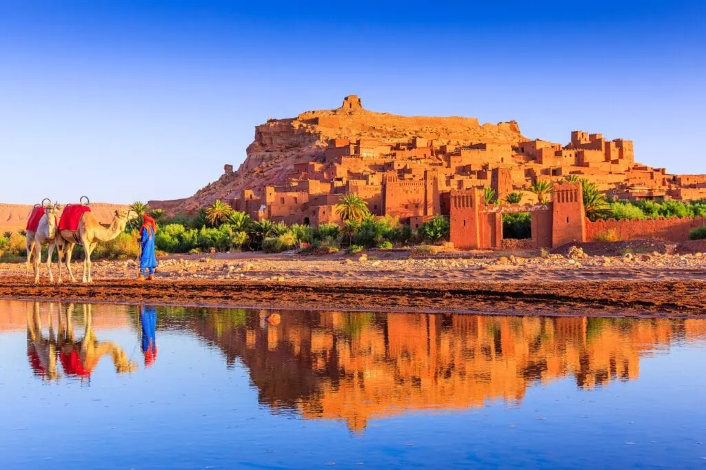 Ksar of Ait-Ben-Haddou with earthen fortified buildings and towers along a hillside, Ouarzazate