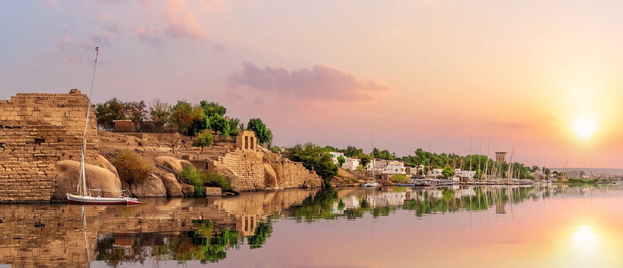 Ancient ruins and traditional boats on Elephantine Island in Aswan