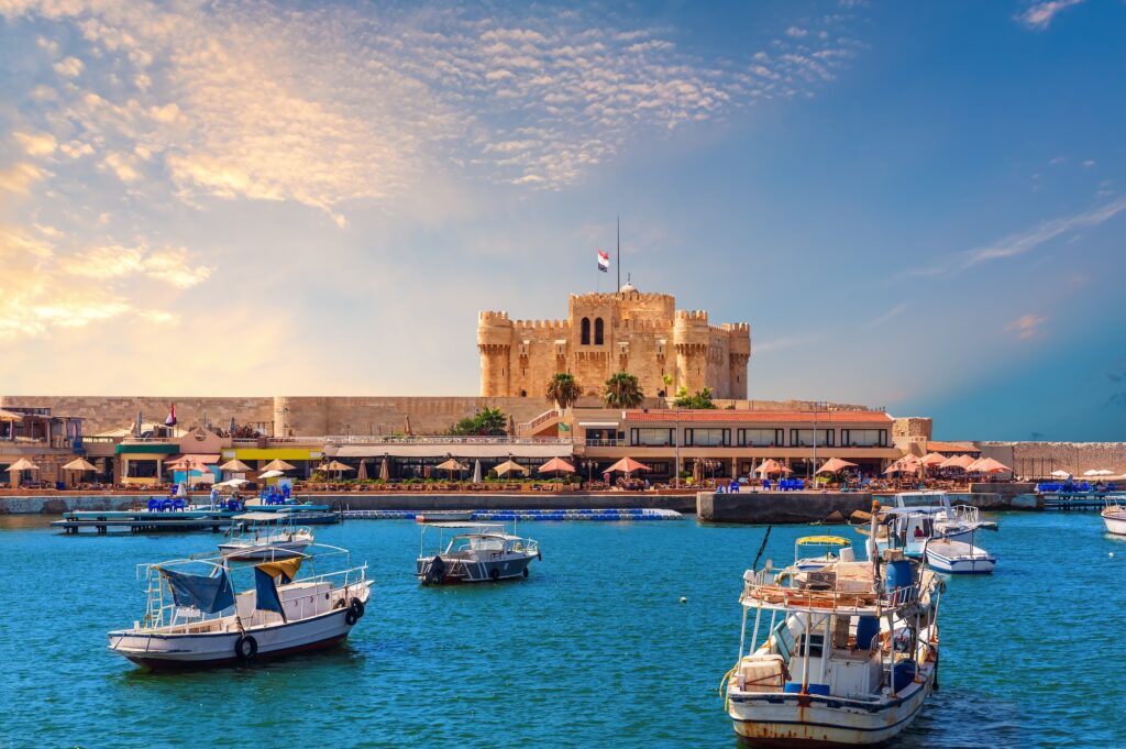 Boats in the harbour near famous Citadel of Qaitbay Alexandria Egypt