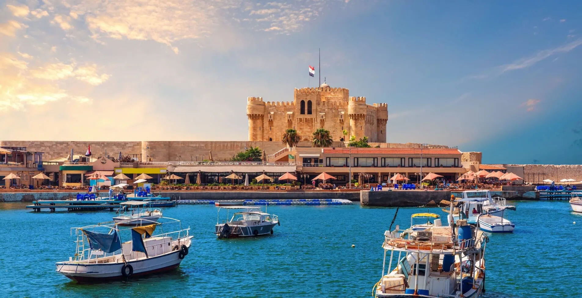 Boats in the harbour near famous Citadel of Qaitbay Alexandria Egypt 1905x976 crop 53 72