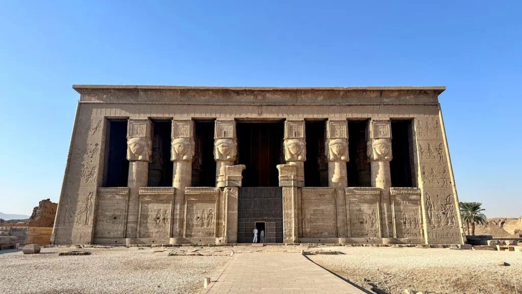 Exterior view of the stone façade and entrance pylons of Dendera Temple, Dendera