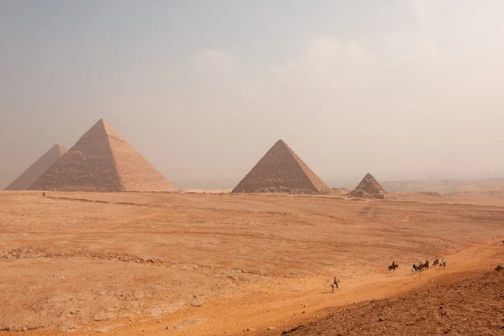 Pyramids rising from the sandy desert plateau, Pyramids of Giza, Giza