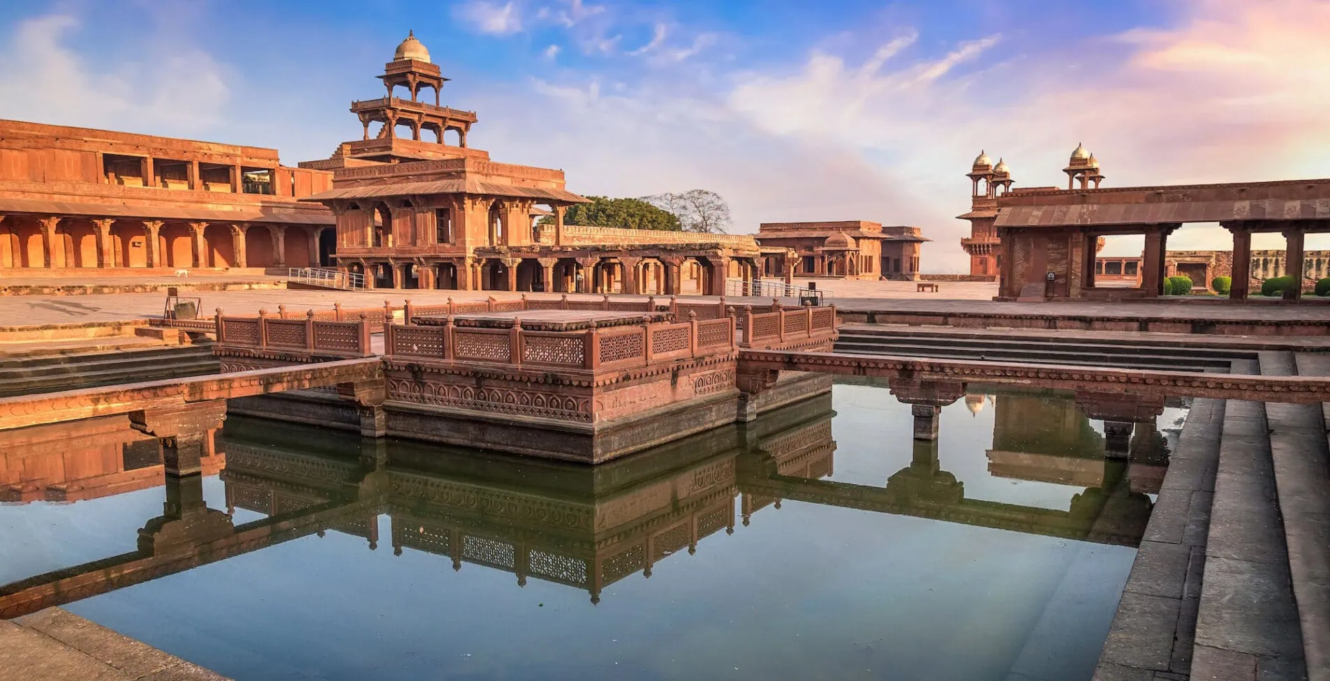 Fatehpur Sikri Agra India at sunset with moody sky 1905x976 crop 50 26