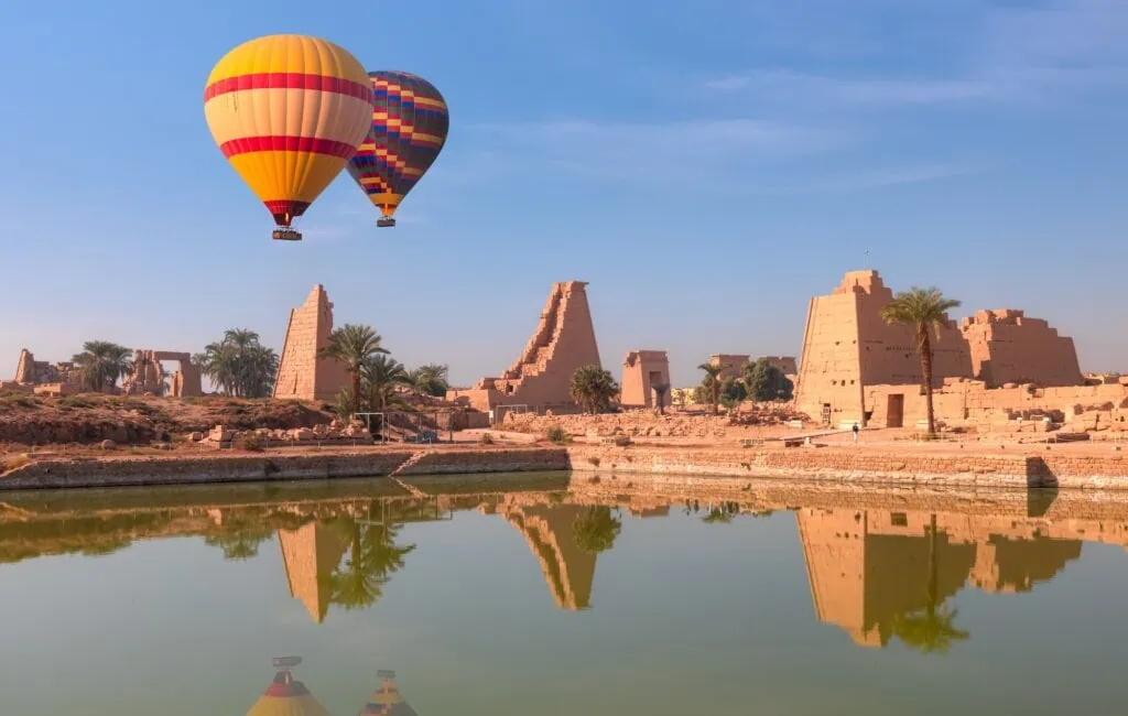 Hot air balloon flying above the columns and courtyards of Karnak Temple, Luxor