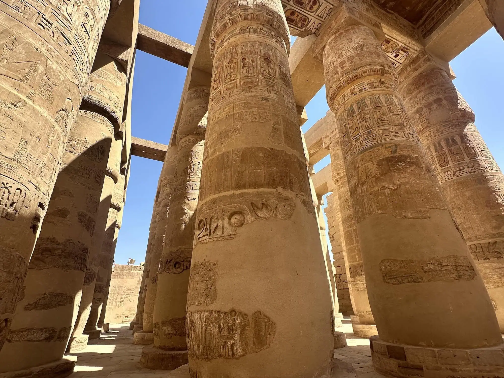 Ancient Egyptian Great Hypostyle Hall at Karnak Temple with massive decorated columns covered in hieroglyphics