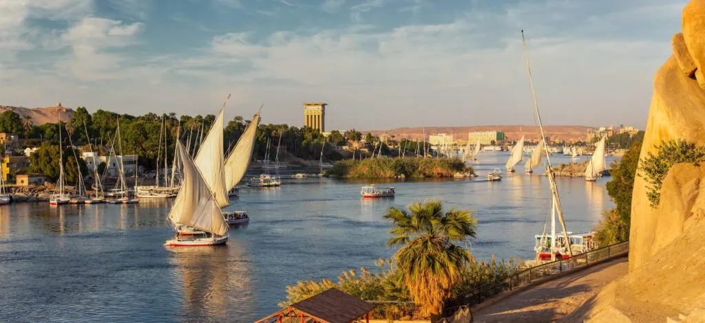 Panoramic view of felucca boats sailing on the Nile River at sunset, Aswan