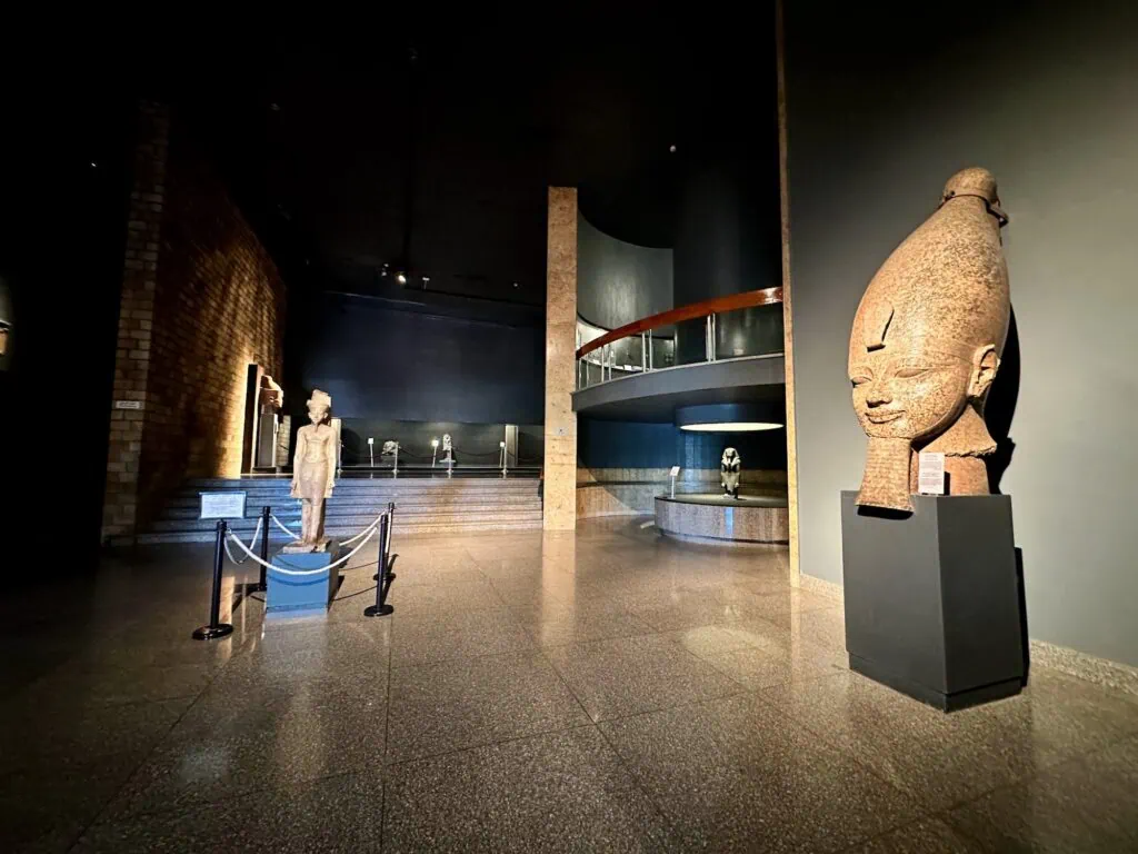 Interior view of the entrance hall with stone architectural elements and museum displays inside the Luxor Museum, Luxor