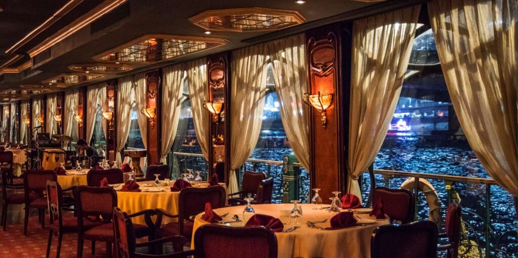 Dining tables on the Maxim dinner cruise overlooking the Nile