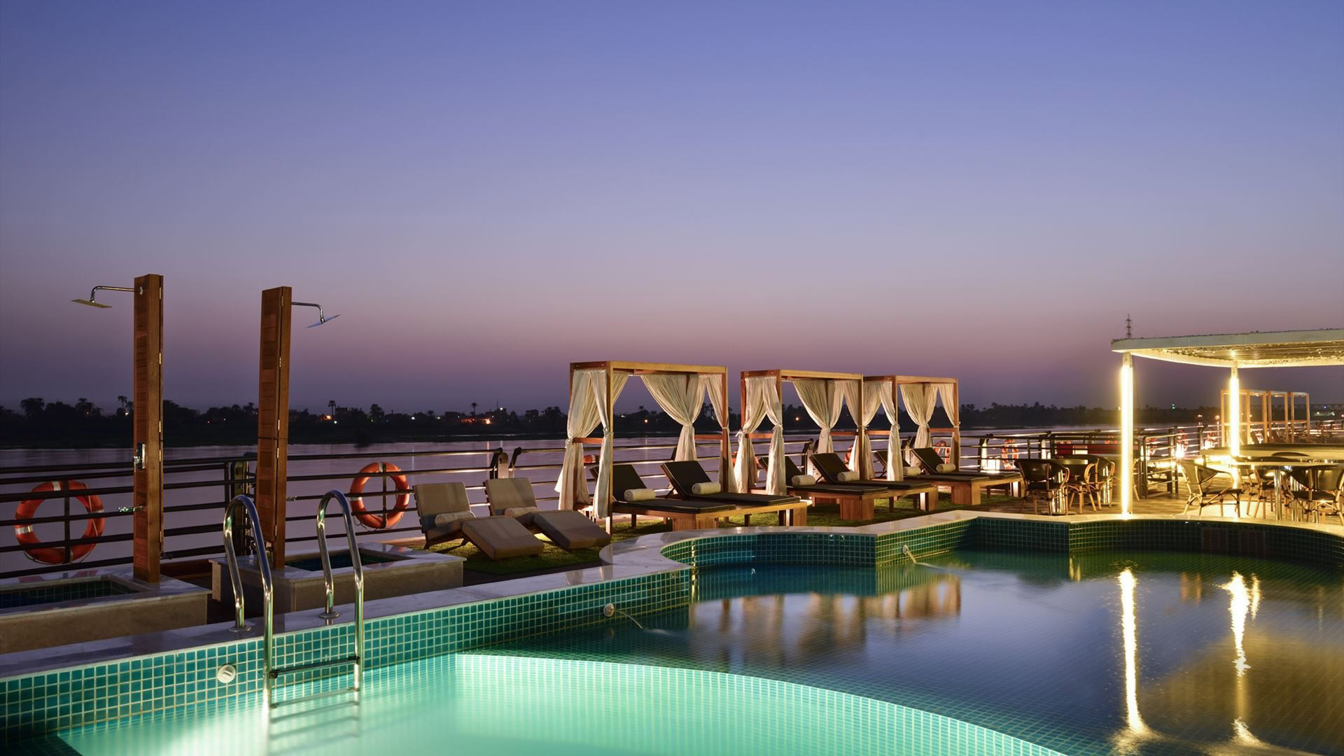 Luxury Nile River cruise ship deck with swimming pool, sun loungers, and premium amenities