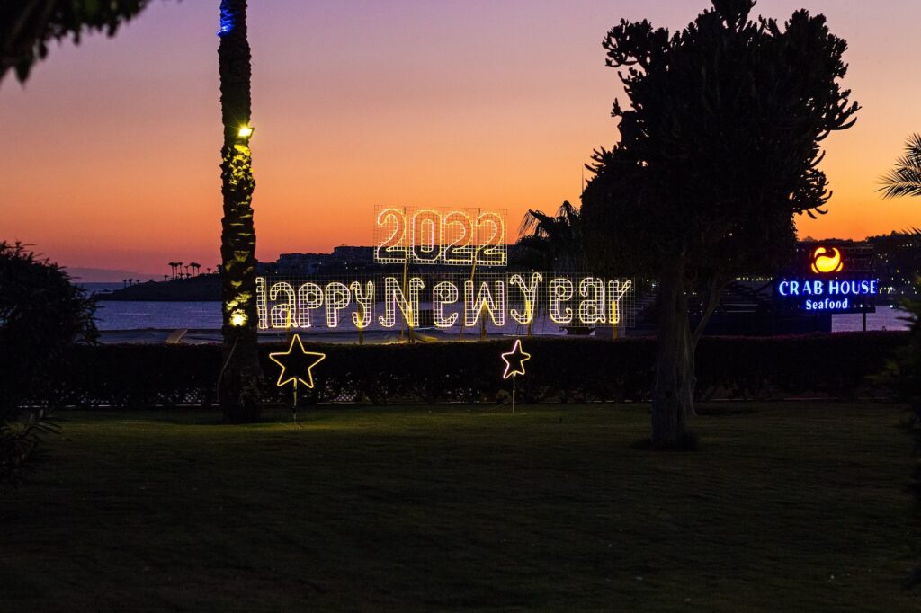 Neon installation reading “Happy New Year” at sunset in a resort hotel on the Red Sea coast, Sharm el Sheikh
