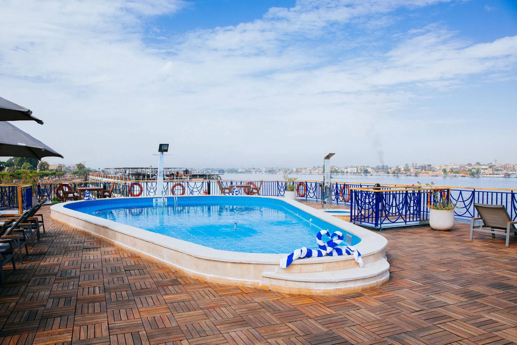 Outdoor pool on MS Amwaj Livingstone with loungers 
