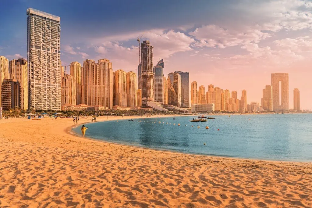 Panoramic view of golden sand, beachfront promenade, and high-rise towers at JBR Beach, Dubai