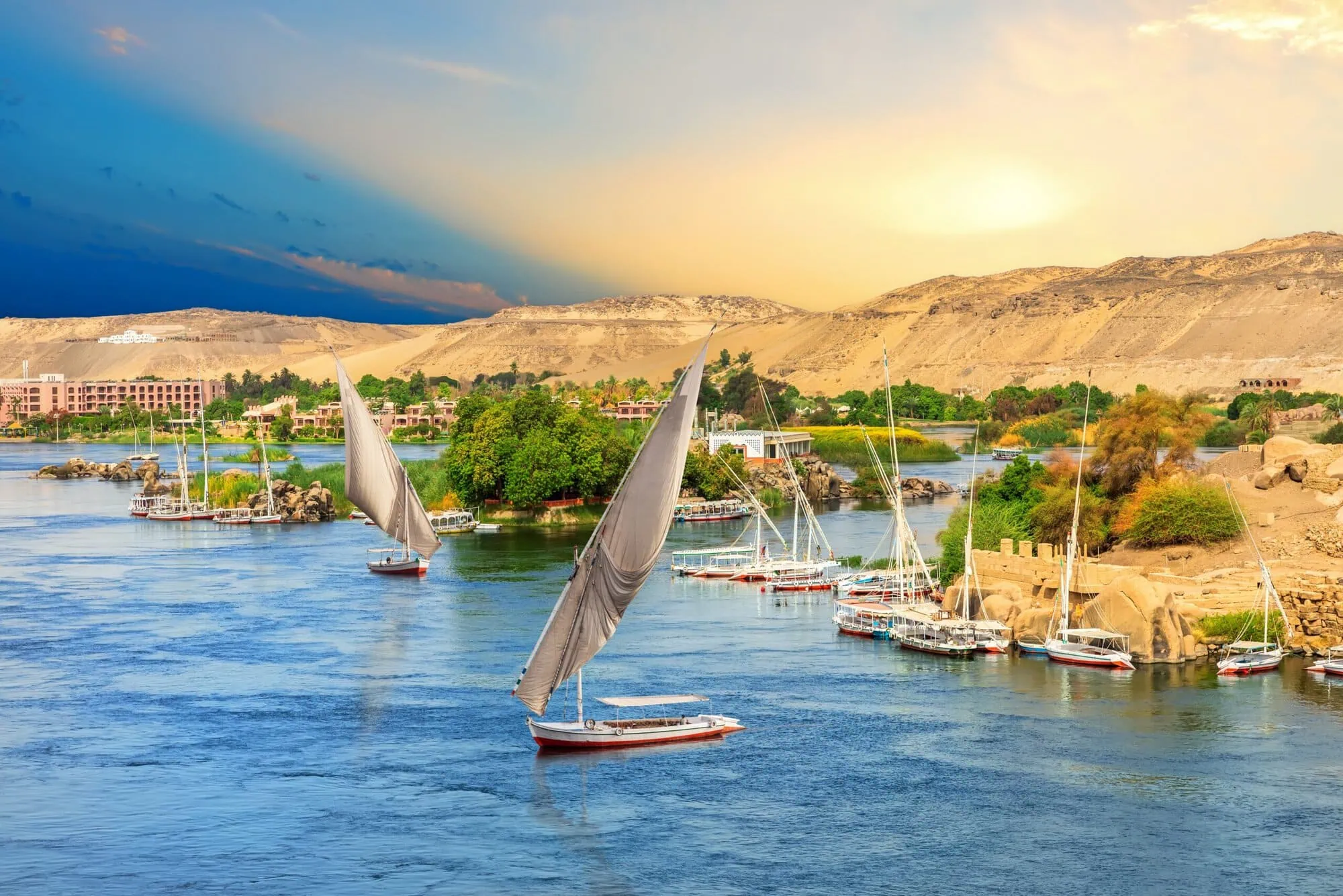 Sailboats in front of the hills of the Nile in Aswan Egypt scaled
