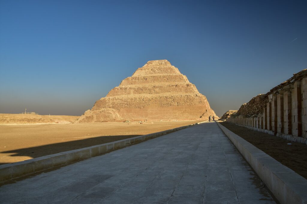 Step Pyramid of Djoser with tiered stone structure rising above the desert plateau, Saqqara, Giza