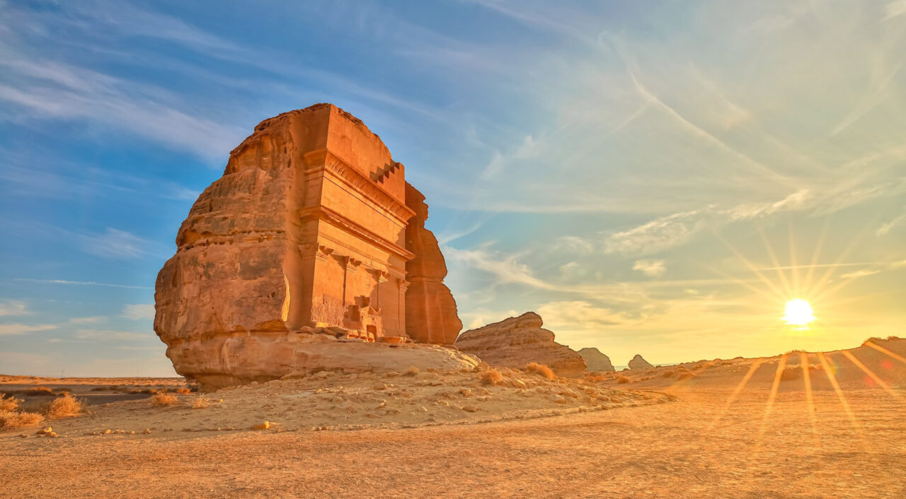 The majestic Qasr Al Farid, also known as the tomb of Lihyan son of Kuza, stands tall in the Hegra desert of AlUla, Saudi Arabia, bathed in the warm glow of the setting sun