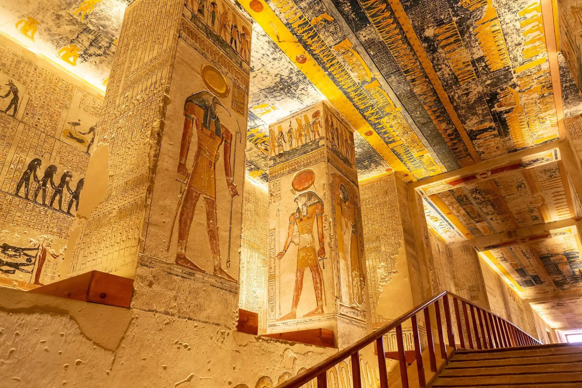 Ancient Egyptian tomb interior with colorful hieroglyphics, murals and sarcophagus in Valley of the Kings