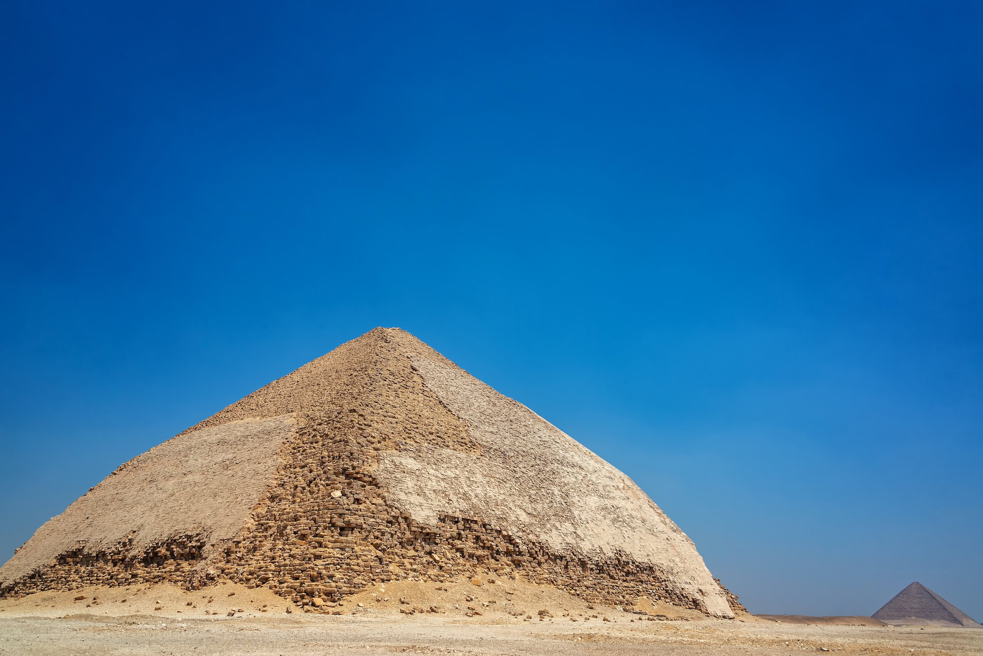 The distinctive Bent Pyramid at Dahshur, Egypt, showcasing its unique angular architecture in the desert