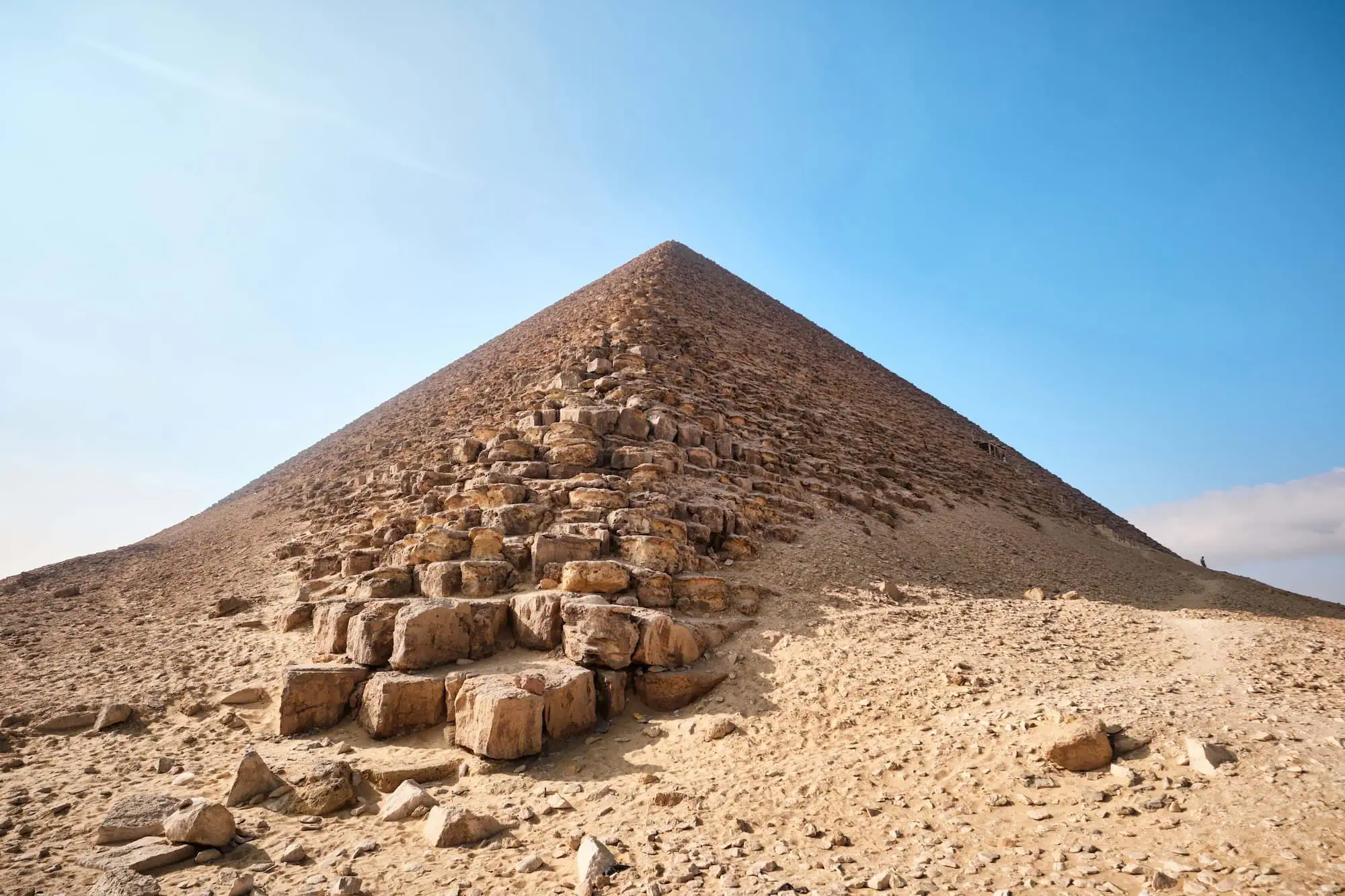 Close-up view of the Red Pyramid showing detailed limestone block construction against blue sky
