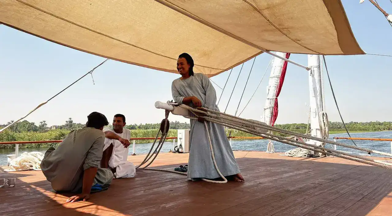 Crew on Nour El Nil Dahabiya preparing the deck while sailing the Nile