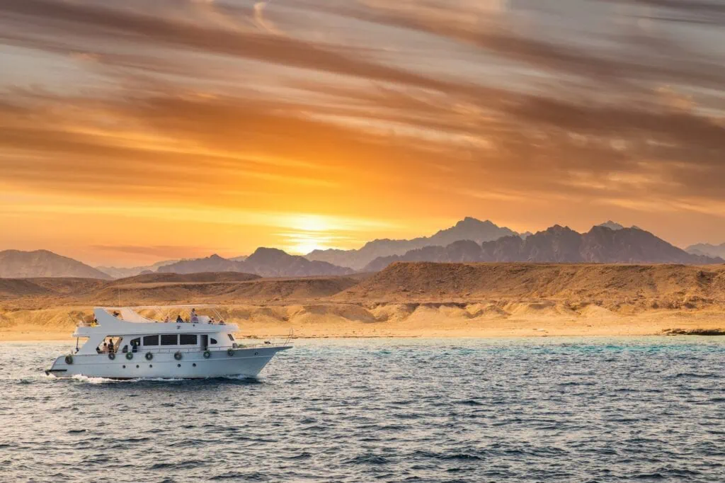 Cruise yacht bow in clear water near a coral reef on the Red Sea coast