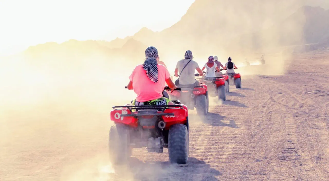 Desert in Egypt. Sharm el Sheikh. Sand and Sand Borkhan. Rock and sunset. Quad Cycle Travel. Excursion with people.
