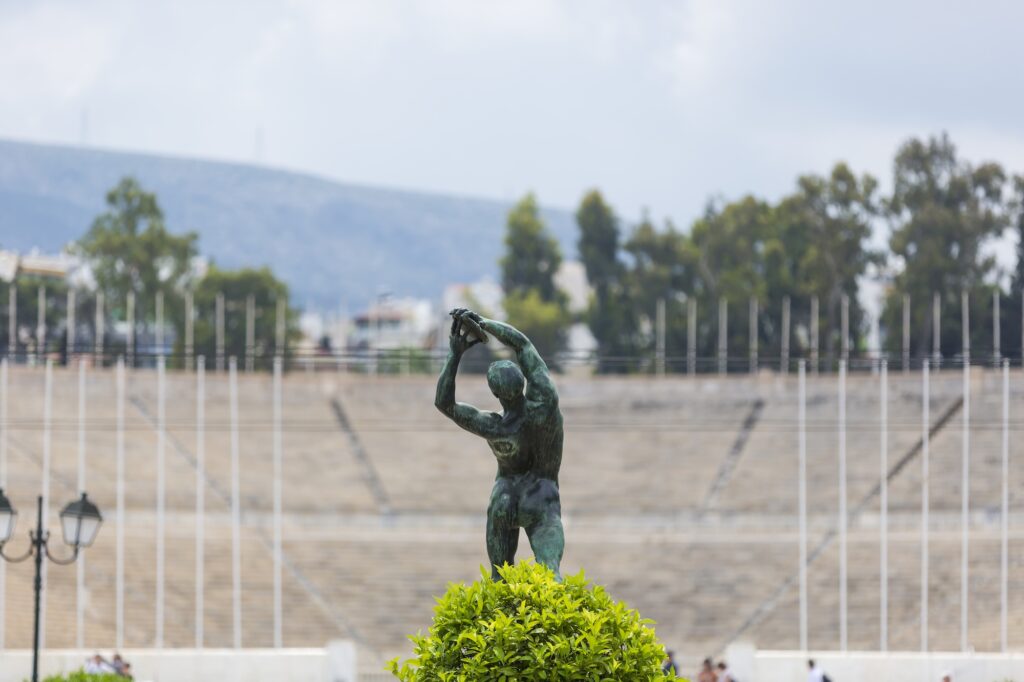 Marble statue at the Panathenaic Stadium with stadium seating in the background, Athens