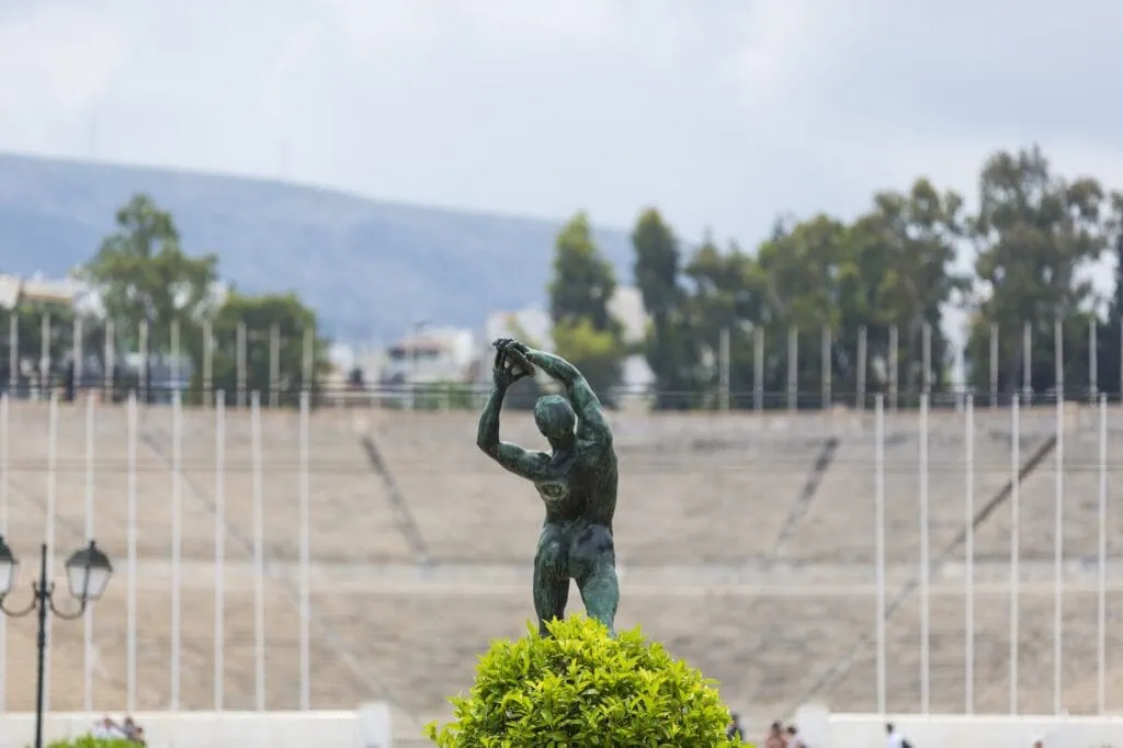 Marble statue at the Panathenaic Stadium with stadium seating in the background, Athens