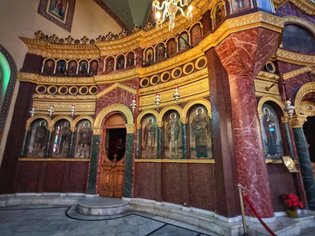 Interior details with stone columns, arches, and Coptic iconography inside Saint George Church, Cairo