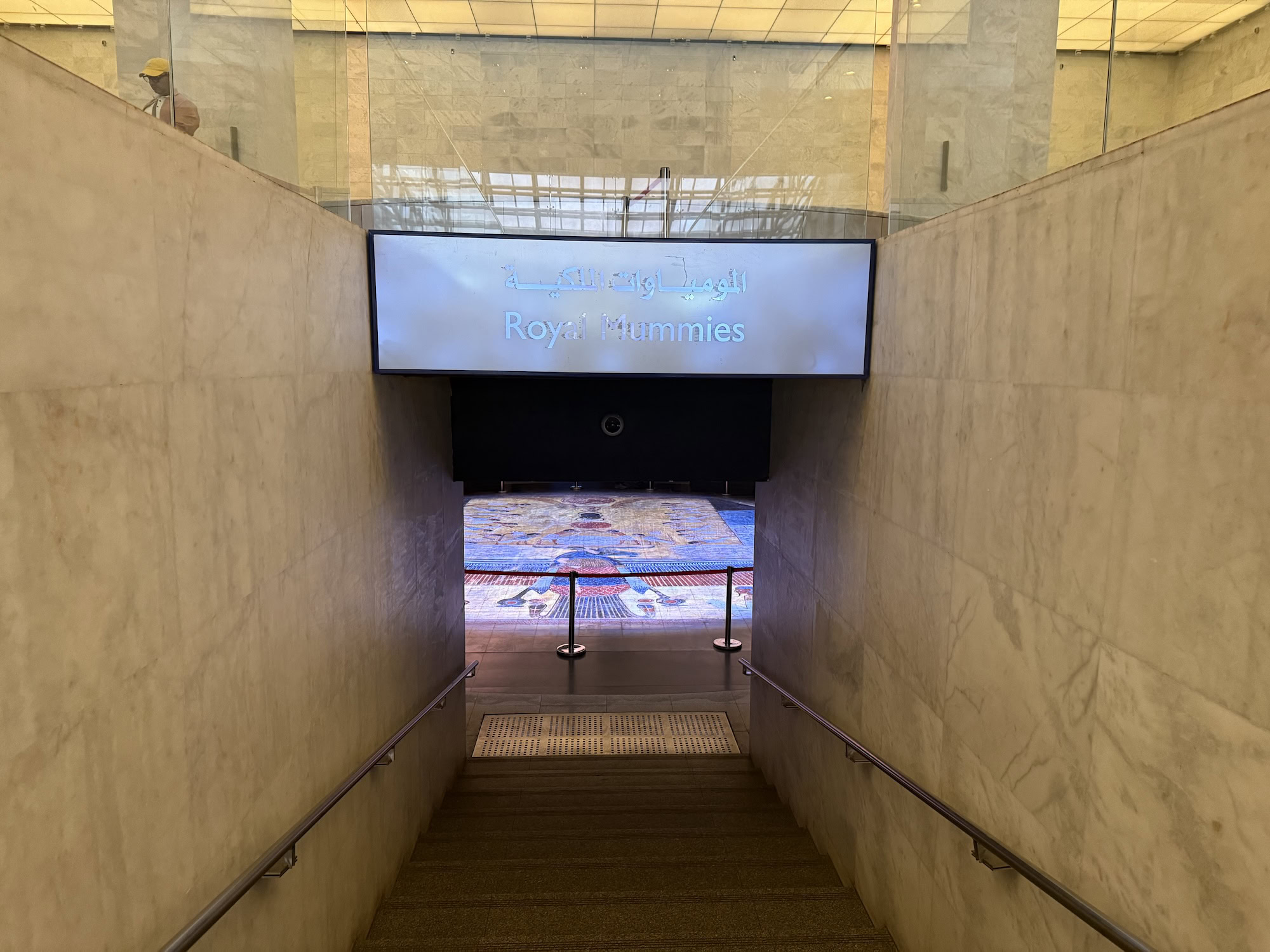 Interior of Royal Mummies Hall with hieroglyphics, marble walls, and modern museum displays