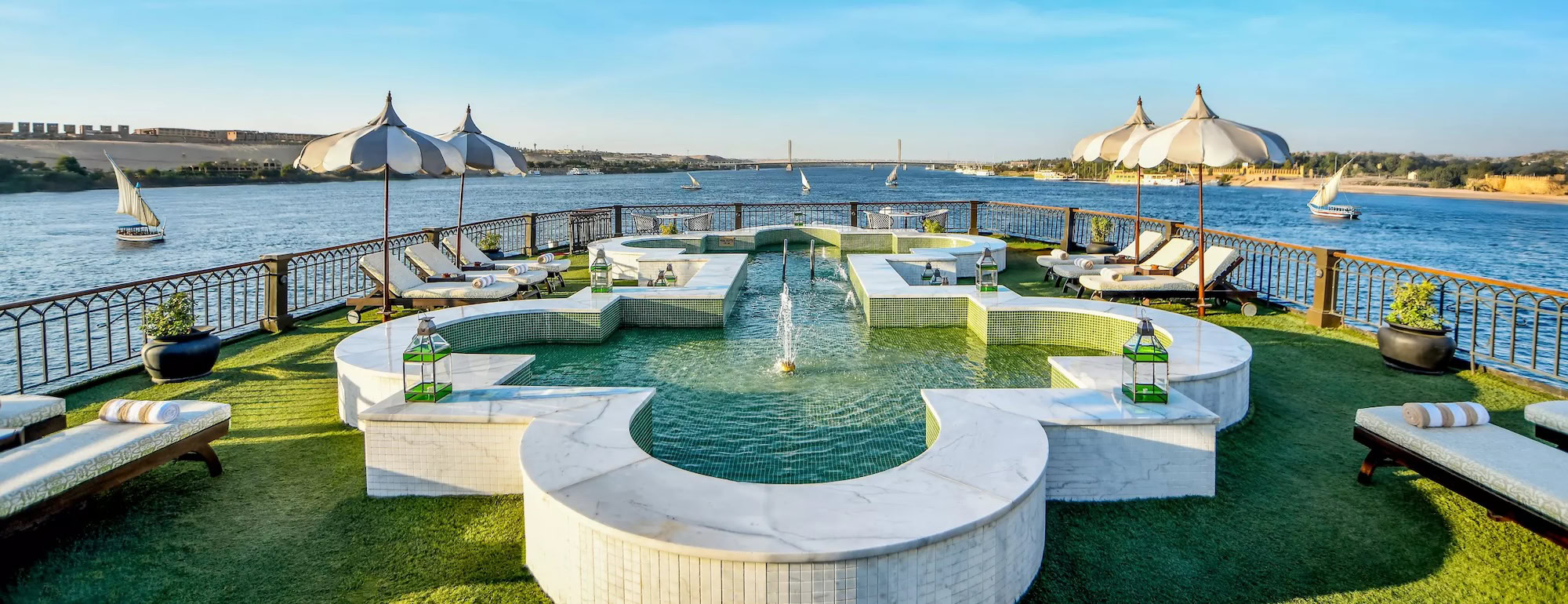 Luxurious Nile River cruise ship deck with pool, umbrellas, and comfortable amenities