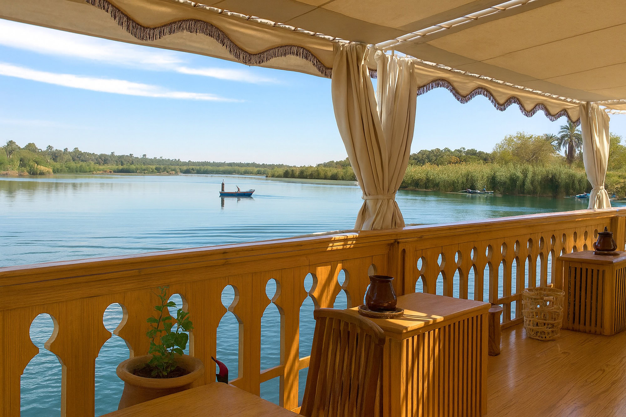 Luxury Nile River cruise boat deck with elegant furnishings and river views