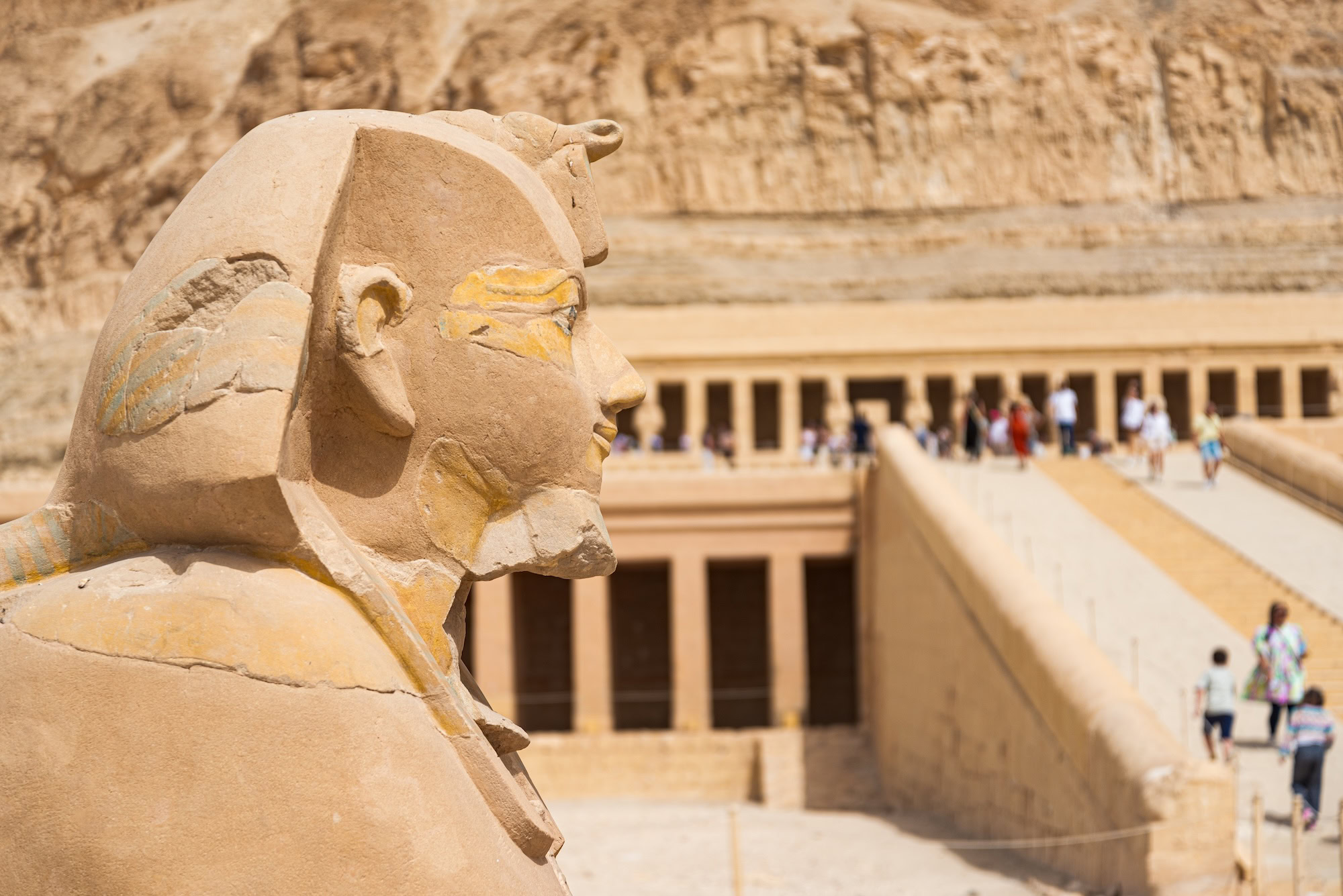 Sphinx statue at Hatshepsut's temple with ancient hieroglyphics and columns