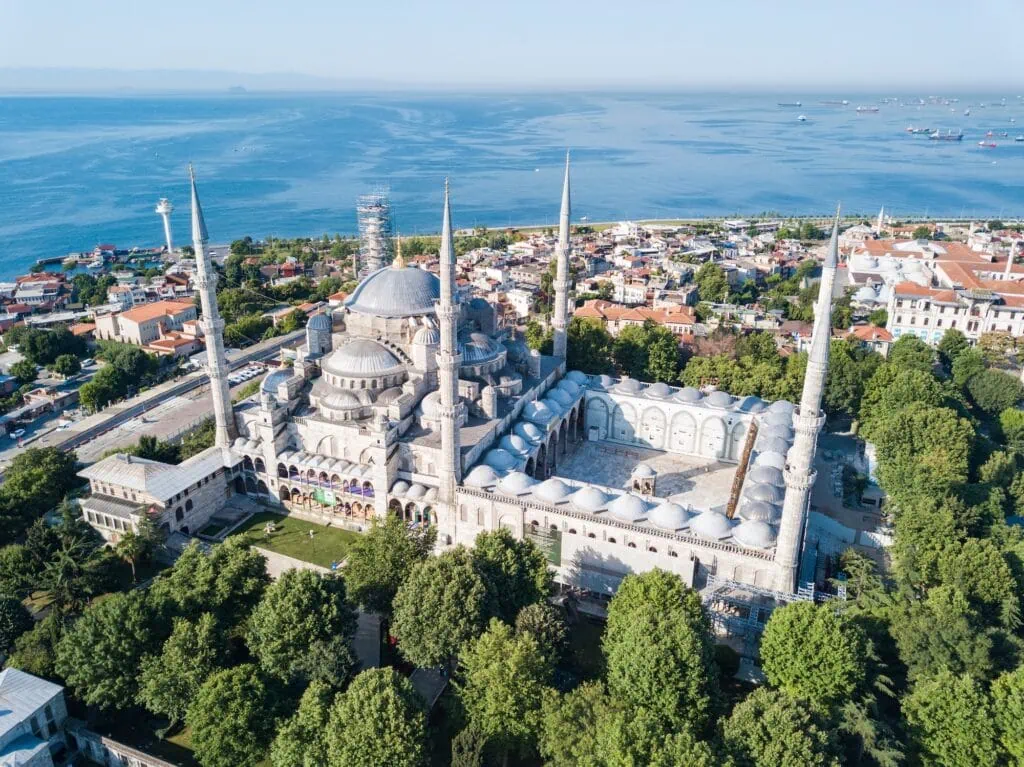 Aerial view of the Sultanahmet Blue Mosque in Istanbul, Turkey, with the city and the sea behind it, a highlight of an Egypt and Turkey tour.